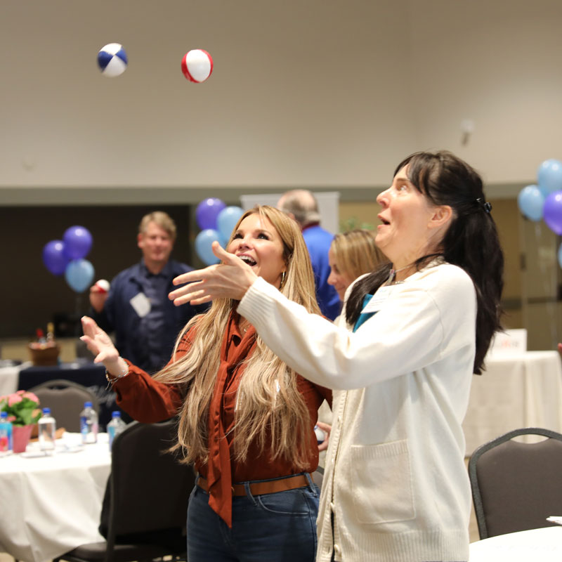 Board member Tara Polley and attendee practice juggling